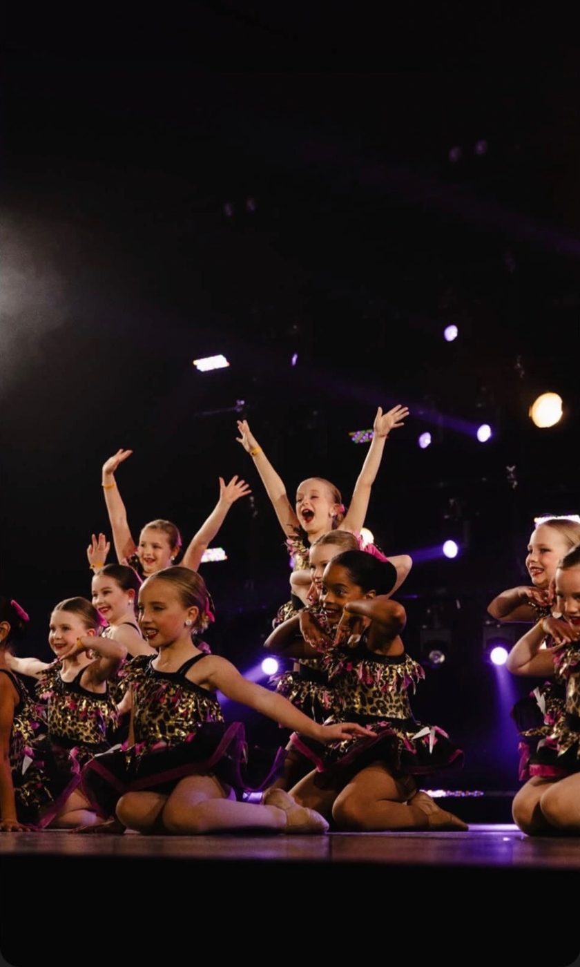Young Fresh Coast Dance students cheering on stage
