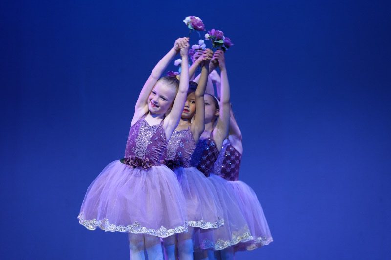 Young Fresh Coast Dance ballerinas holding flowers